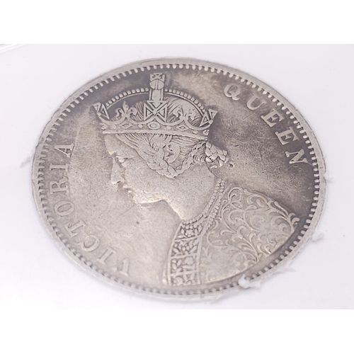 1353 - A Sangs 1876 Silver Indian One Rupee Coin. Comes in a sealed container.