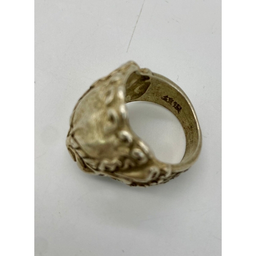 280 - A vintage Chinese silver ring with a Mythological Chinese Lion. Chinese marks on the inside of the s... 