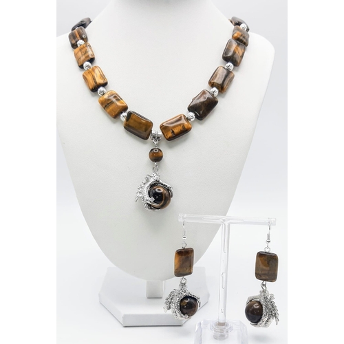 301 - A substantial tiger’s eye necklace and earrings set with eagle claw pendants, beads 20 x 15 x 7 mm. ... 