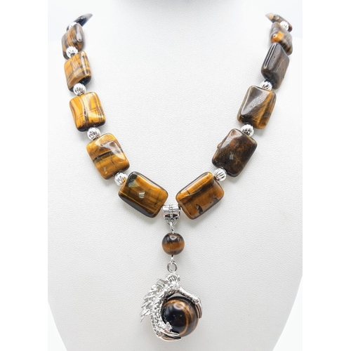 301 - A substantial tiger’s eye necklace and earrings set with eagle claw pendants, beads 20 x 15 x 7 mm. ... 