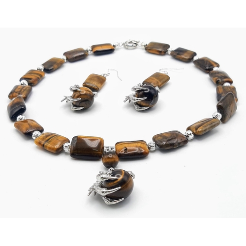 301 - A substantial tiger’s eye necklace and earrings set with eagle claw pendants, beads 20 x 15 x 7 mm. ... 