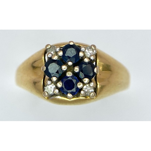 4 - An 18K Yellow Gold Sapphire and Diamond Ring. A cross of four central sapphires with a diamond in ea... 