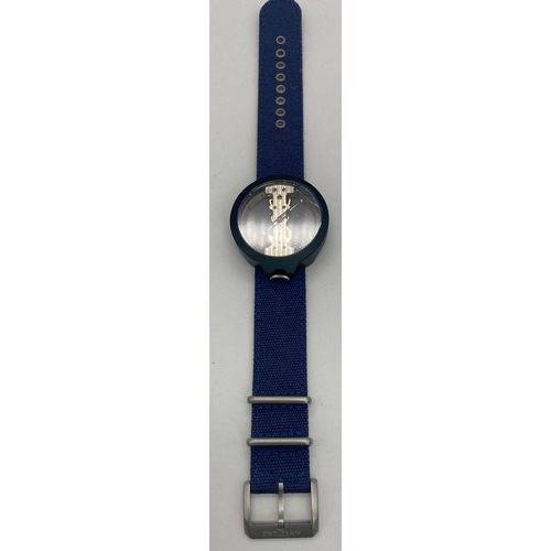 869 - A Verticale Mechanical Top Winder Gents Watch. Denim blue textile strap. Black ceramic gilded skelet... 