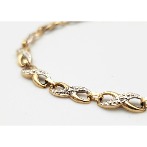 302 - A Vintage 9K Yellow Gold and Diamond Spacer Crossover Link Bracelet. 18cm length. 2.37g total weight... 