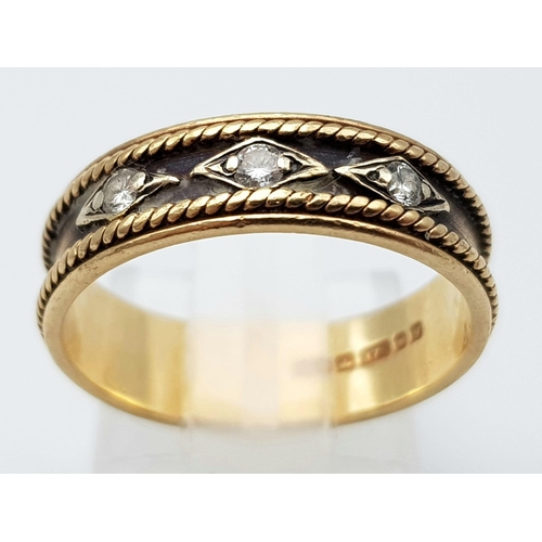 36 - A Vintage 9K Yellow Gold and Diamond Ring. Rope borders with three round cut diamonds. Size O. 2.97g... 