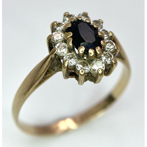 400 - A Vintage 9K Yellow Gold Diamond and Sapphire Ring. Central sapphire with a diamond halo. Size N. 1.... 