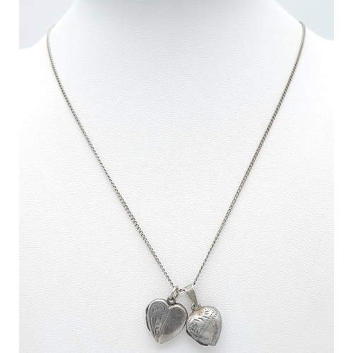 1012 - A vintage sterling silver necklace with 2 silver heart locket pendants. Total weight 5.6G. Total len... 