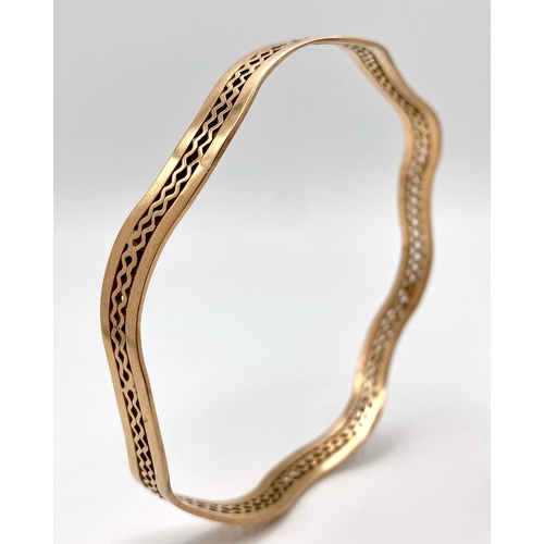 170 - A Vintage 9K Rose Gold Undulating Large Bangle. Pierced geometric decoration. 17.6g weight.