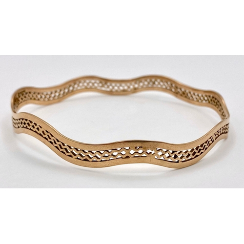 170 - A Vintage 9K Rose Gold Undulating Large Bangle. Pierced geometric decoration. 17.6g weight.