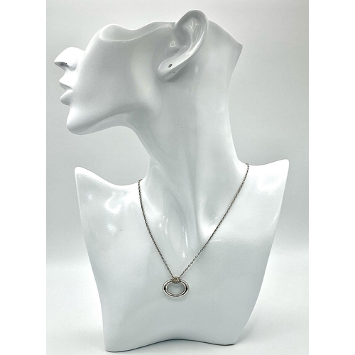 298 - An 18K White Gold and Diamond Oval Pendant on an 18K White Gold Disappearing Necklace. 2.5cm and 44c... 