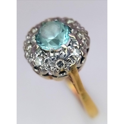 312 - A Vintage 18K Yellow Gold Aquamarine and Diamond Ring. Central aquamarine with a diamond halo. Size ... 