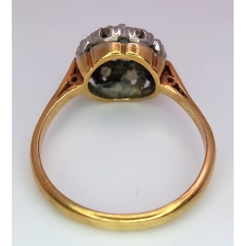 312 - A Vintage 18K Yellow Gold Aquamarine and Diamond Ring. Central aquamarine with a diamond halo. Size ... 