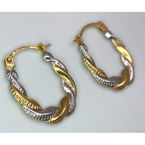 437 - A Pair of 9K Bi-Colour Gold Oval Hoop Twist Earrings. 0.44g weight.