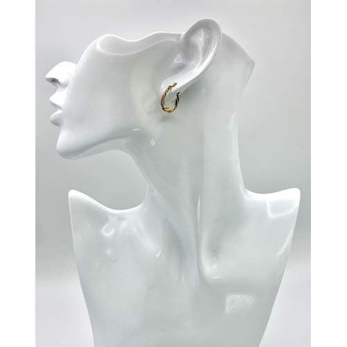 437 - A Pair of 9K Bi-Colour Gold Oval Hoop Twist Earrings. 0.44g weight.