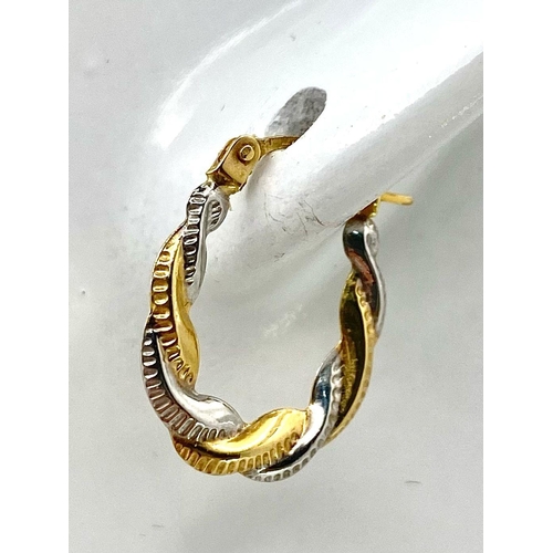 437 - A Pair of 9K Bi-Colour Gold Oval Hoop Twist Earrings. 0.44g weight.