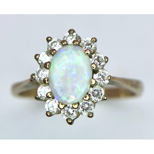 456 - A 9K Yellow Gold, Opal and Diamond Ring. Central colour-play opal with diamond halo. Size O. 2.27g w... 