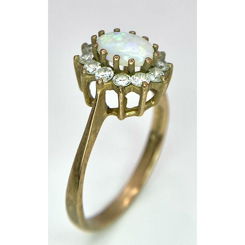 456 - A 9K Yellow Gold, Opal and Diamond Ring. Central colour-play opal with diamond halo. Size O. 2.27g w... 