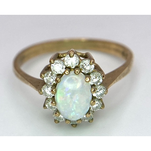 456 - A 9K Yellow Gold, Opal and Diamond Ring. Central colour-play opal with diamond halo. Size O. 2.27g w... 