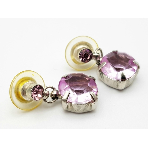 1166 - A matching set of Purple stone jewellery include a pair of drop earrings and a solitaire ring.