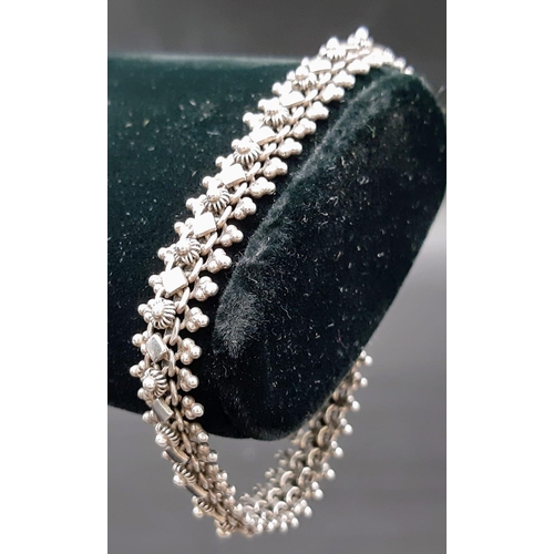 1350 - A sterling silver beautiful ornate link bracelet. Total weight 12.9G. Total length 18cm. Please see ... 