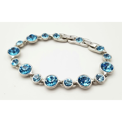 1371 - A matching set of white metal faceted blue stone jewellery include a pair of stud earrings, a link b... 