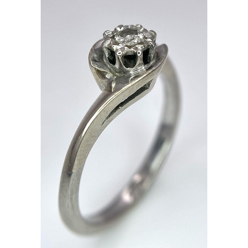 351 - An 18K White Gold Diamond Crossover Ring. 0.10ct brilliant round cut diamond. Size N. 4g total weigh... 