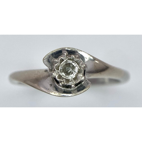 351 - An 18K White Gold Diamond Crossover Ring. 0.10ct brilliant round cut diamond. Size N. 4g total weigh... 