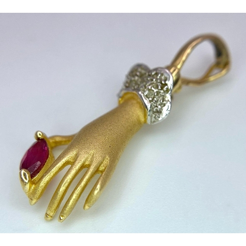 430 - A 14K Yellow Gold, Diamond and Ruby Hand Pendant. A diamond wristed feminine hand gently caresses a ... 