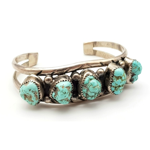 652 - A Vintage Native American Indian Silver and Kingman Turquoise Cuff Bracelet. 34.2g total weight.