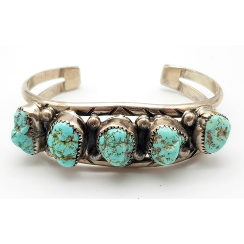 652 - A Vintage Native American Indian Silver and Kingman Turquoise Cuff Bracelet. 34.2g total weight.