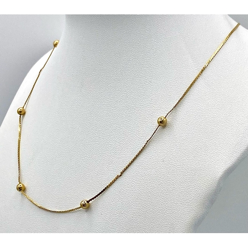 72 - A 14K Yellow Gold Necklace with Ball Decoration. 40cm. 2g weight.