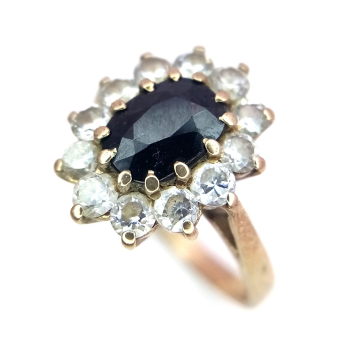 883 - A 9K Yellow Gold Sapphire and White Stone Ring. Size P. 3.46g total weight.