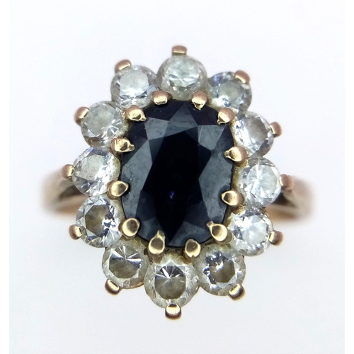 883 - A 9K Yellow Gold Sapphire and White Stone Ring. Size P. 3.46g total weight.