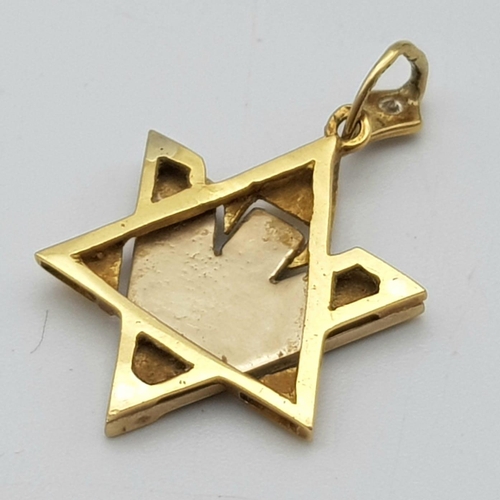 563 - A Futuristic 9K White and Yellow Gold Star of David Pendant. 
Single diamond decoration. 3cm. 3.8g w... 