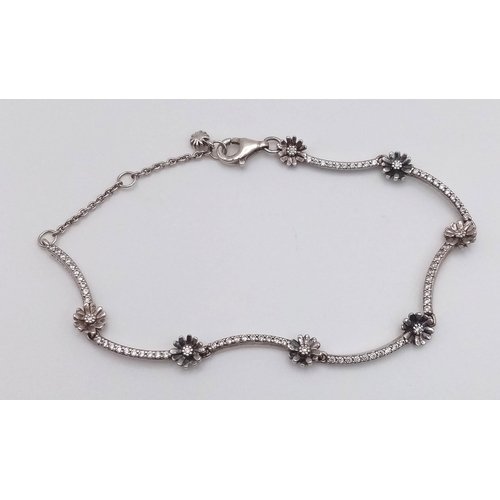 851 - A sparkling Pandora 925 silver stone set daisy flower link bracelet. Total weight 4.4G. Total length... 