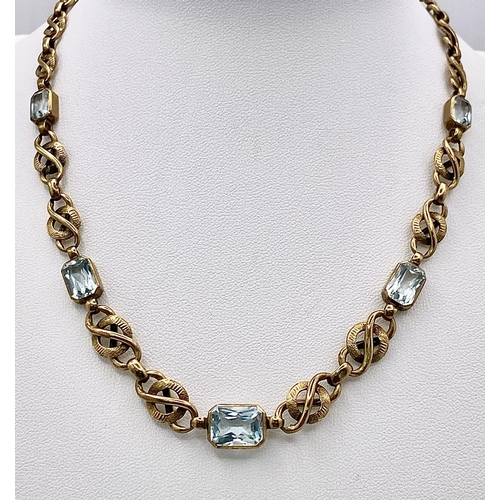 892 - A Vintage 9K Yellow Gold and Aquamarine Intricate Link Necklace. 38cm. 12.5g total weight.