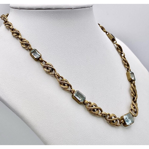 892 - A Vintage 9K Yellow Gold and Aquamarine Intricate Link Necklace. 38cm. 12.5g total weight.