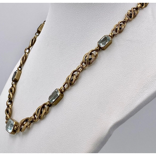 892 - A Vintage 9K Yellow Gold and Aquamarine Intricate Link Necklace. 38cm. 12.5g total weight.