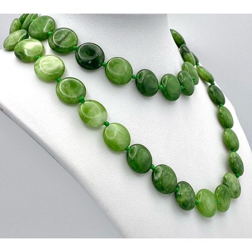 247 - A Green and White Jade Coin Bead Necklace. 14mm beads. 68cm length.