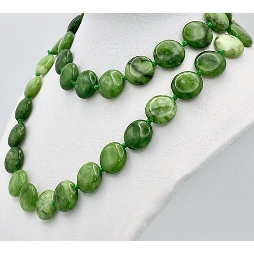 247 - A Green and White Jade Coin Bead Necklace. 14mm beads. 68cm length.