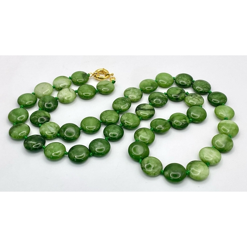 247 - A Green and White Jade Coin Bead Necklace. 14mm beads. 68cm length.