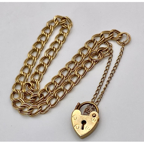 618 - A 9K Yellow Gold Curb Link Bracelet with Heart Clasp. 4.83g weight. 18cm.