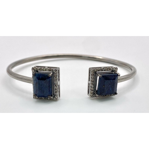 59 - A Blue Sapphire and Diamond Cuff Bracelet.  Blue Sapphire- 10.85ctw. Diamonds- 0.50ctw. Set in 925 s... 