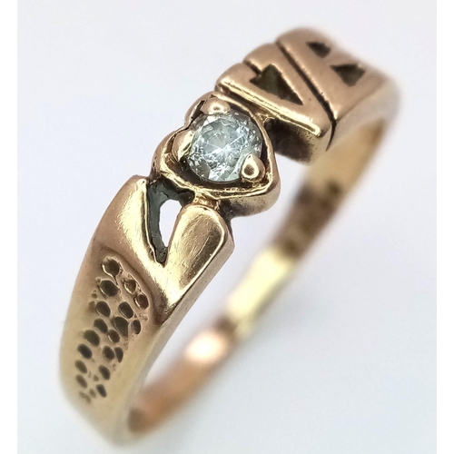 596 - A 9K Yellow Gold 'Love' Ring with White Stone Decoration. 
Size O/P. 2.52g weight.