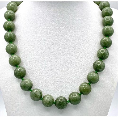 722 - A Rich Green Jade Beaded Necklace. 14mm beads. 56cm.