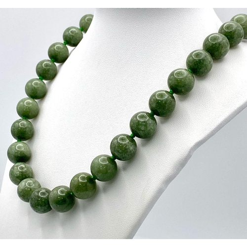 722 - A Rich Green Jade Beaded Necklace. 14mm beads. 56cm.