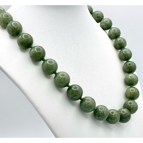 722 - A Rich Green Jade Beaded Necklace. 14mm beads. 56cm.