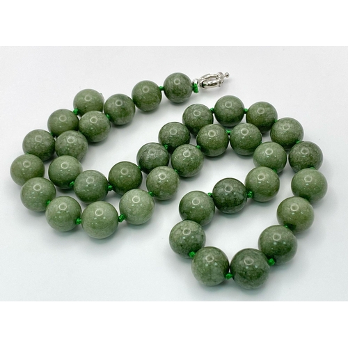 722 - A Rich Green Jade Beaded Necklace. 14mm beads. 56cm.