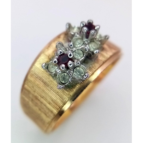 890 - An 18K Yellow Gold Garnet and Diamond Ring. Two small garnets with diamond surrounds. Size N. 3.7g w... 