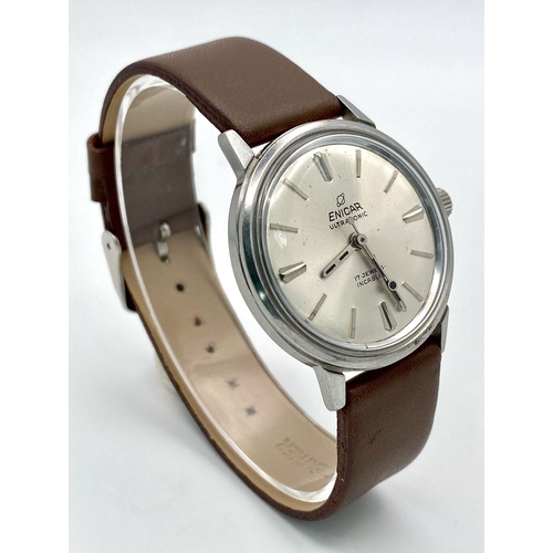 1002 - A Vintage Enicar Mechanical Gents Watch. Brown leather strap. Stainless steel case - 34mm. Silver to... 